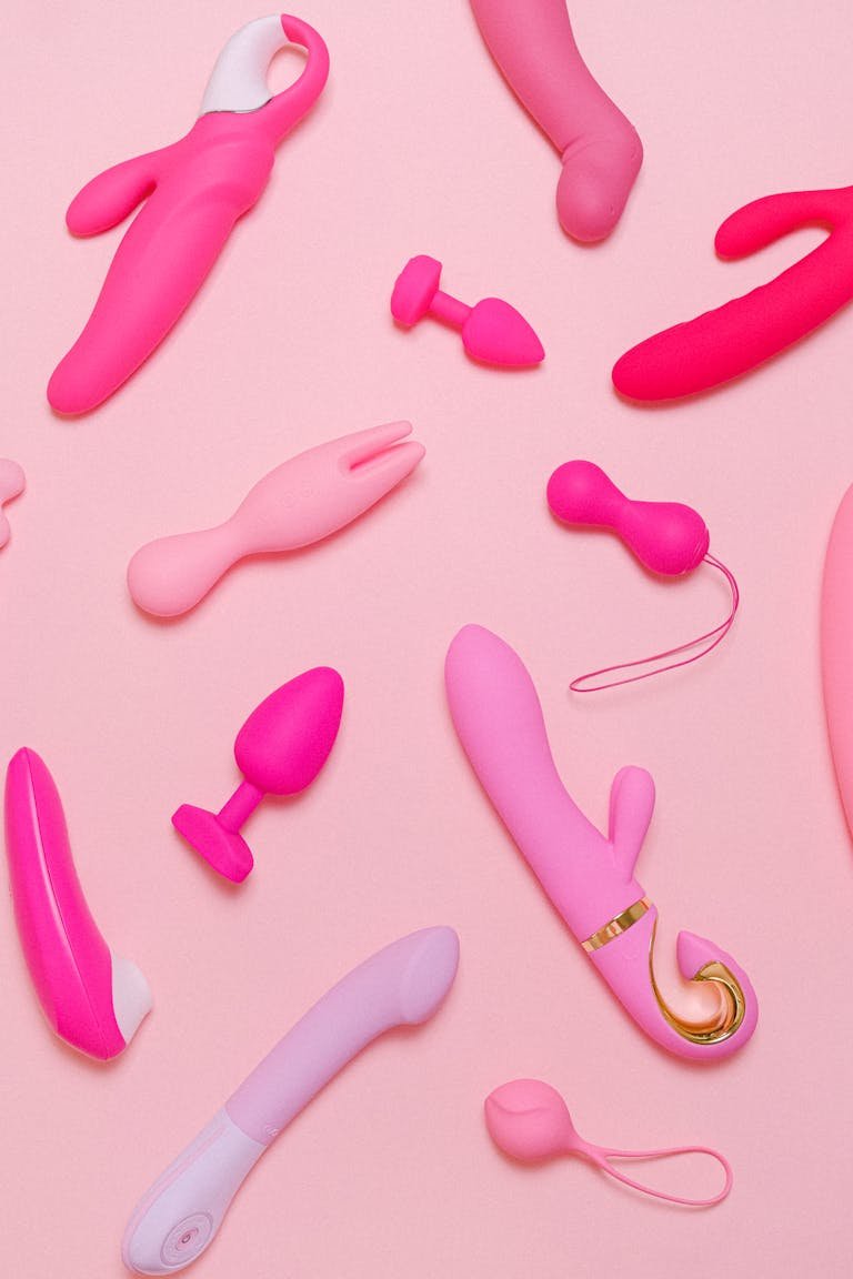 Imagen Sheixy Shop: juguetes sexuales rosas como vibradores y accesorios de silicón sobre fondo pastel